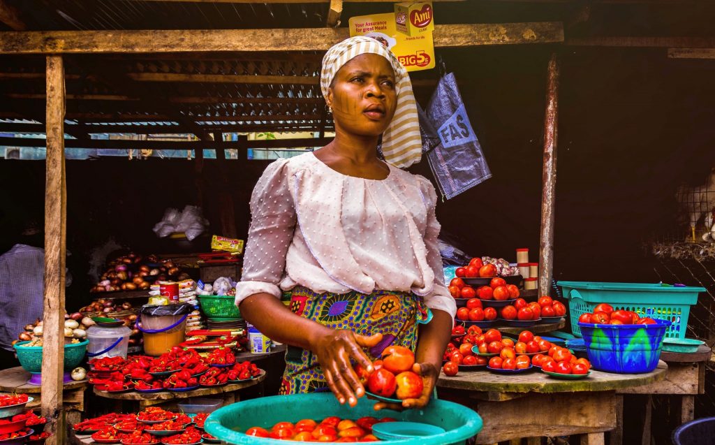 woman-holding-tomatoes-3213283